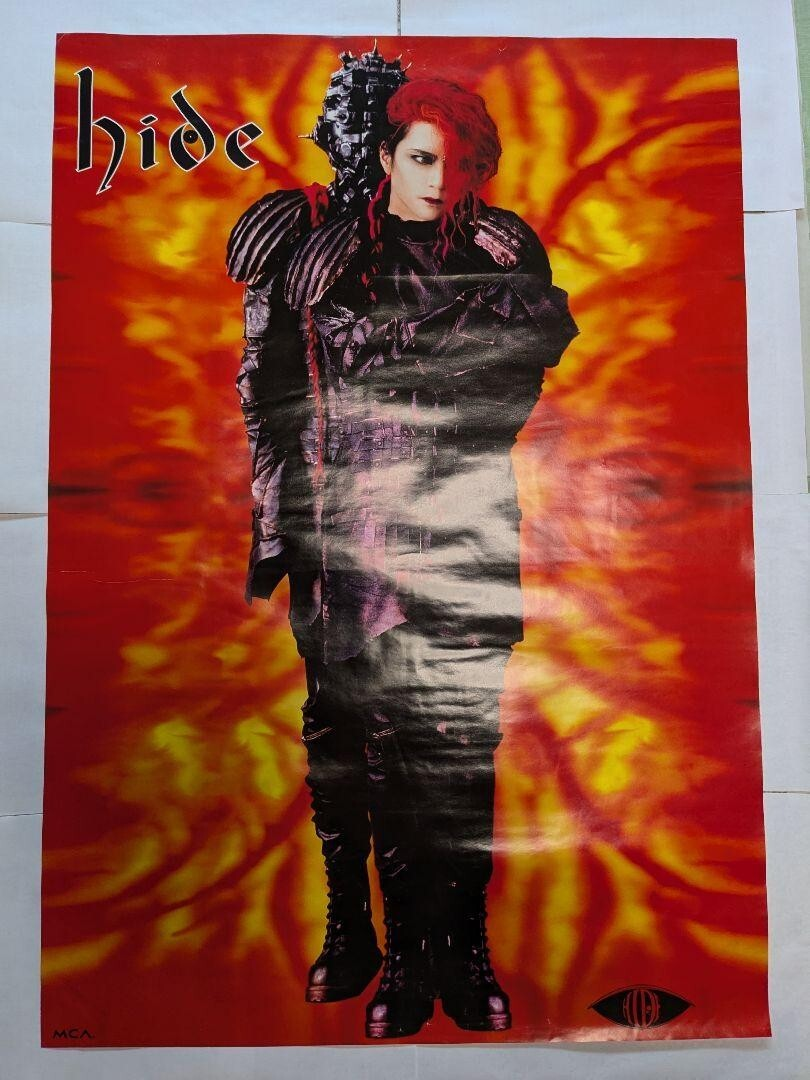 1994 Japanese Hide Your Face promotional poster showing hide in red hair beside a figure in spiked metallic armour against a flame background.