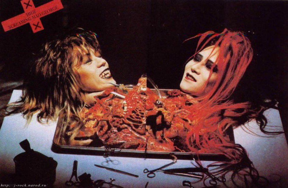 hide and Screaming Mad George appear as two severed heads on a metal tray joined by organs, with a red X logo printed over the centre.