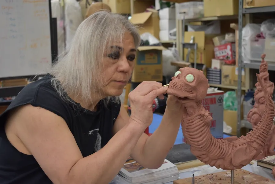 Screaming Mad George concentrates on a clay creature head at his Osaka workbench.